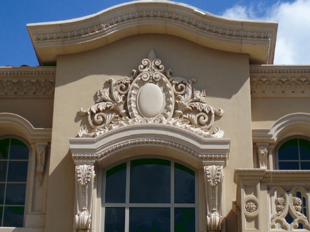 Elaborate cast stone decorative pediment and window surround on luxury residence