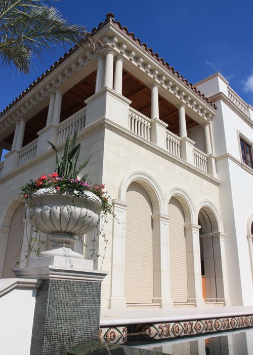 Luxury Mediterranean estate with cast stone columns, arched loggia, and ornate balustrades by CGA Stoneworks
