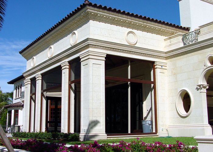 Palm Beach estate entrance with cast stone pilasters, balustrades, and natural stone steps