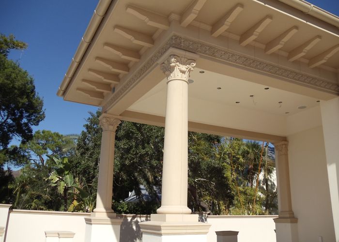Ornate Corinthian cast stone column capital with dentil cornice